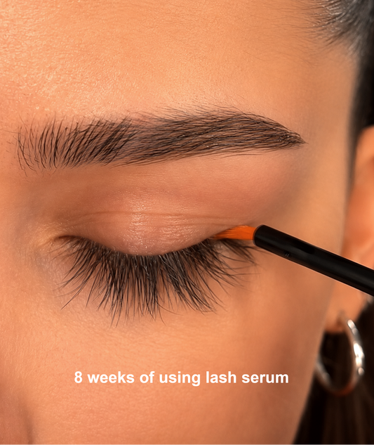 Close-up of lash serum applicator being applied along the lash line