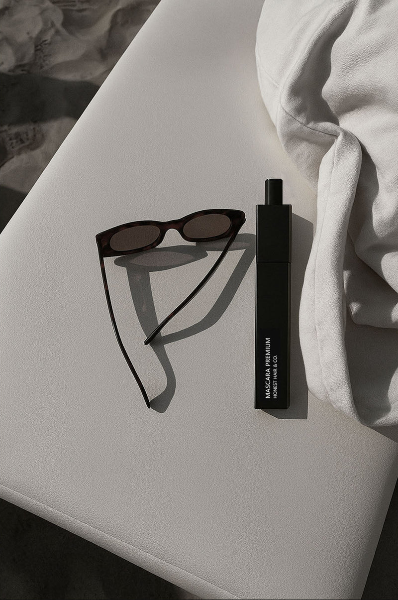 Classy aesthetic image of sunglasses and mascara