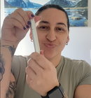 happy customer holding eyelash growth serum 