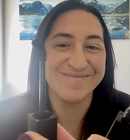 Person holding the honest hair and co mascara. Happy customer